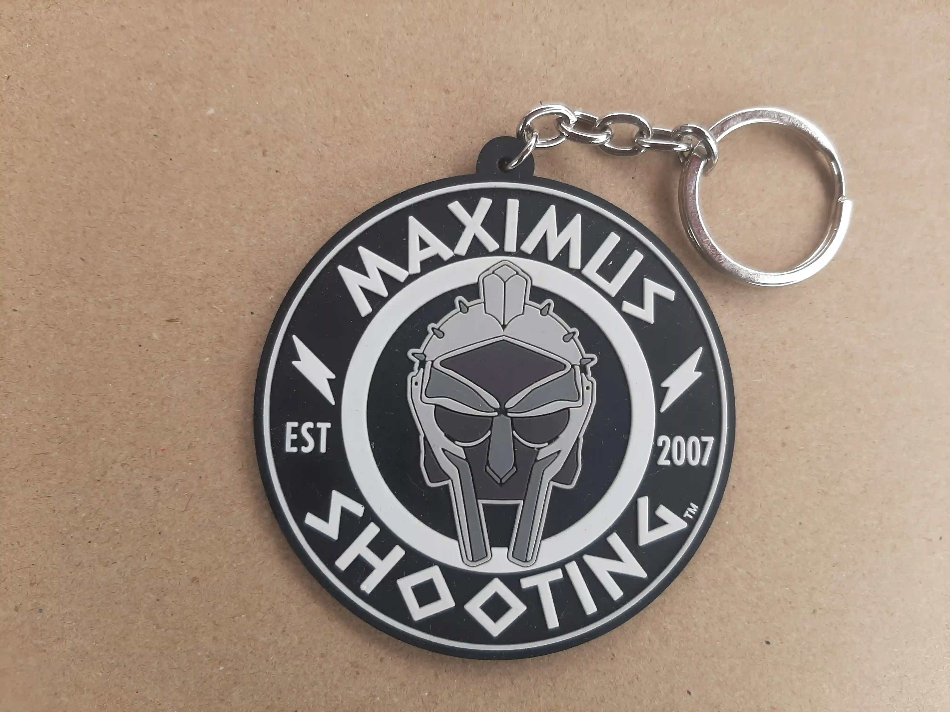 PVC Key Chain for the Maximums Shooting family. Steel Master Champion is empowered with a Patch Key Chain of PVC + Silicone Master Maximus White Shooting_Championship